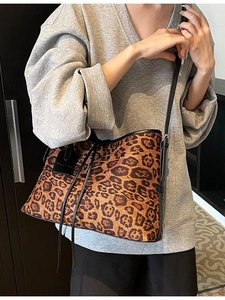 Vintage leopard print tote bag with black leather straps and fashion tag for women