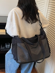 Black large capacity tote travel bag with checkered pocket and adjustable shoulder strap