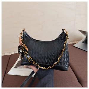 Detail of black woven crescent bag with gold chain strap and vintage wooden beads