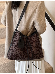 Vintage leopard print tote bag with adjustable leather straps worn by model