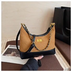 Detail of brown quilted suede bag with gold twist lock and woven chain strap