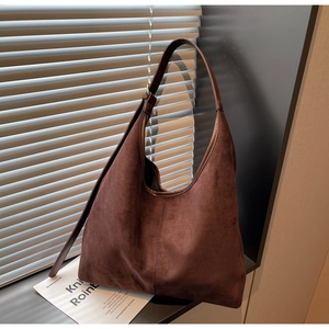 Detailed close-up of a dark brown suede Hobo bag with visible soft texture and stitching