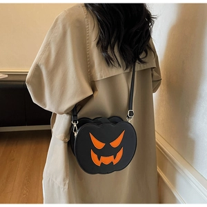 Detail of Halloween pumpkin crossbody bag in black matte faux leather on beige coat