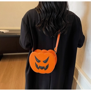 Detail of pumpkin crossbody bag with cute smiling face and adjustable shoulder strap