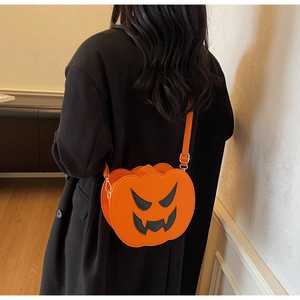 Detail of pumpkin crossbody bag with black ghost face on orange high-quality PU leather