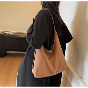 Close-up of a large suede tote bag in brown featuring soft texture and spacious design