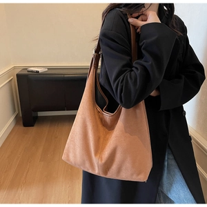 Detailed view of brown suede hobo bag with vintage stitching and large capacity