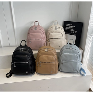 Detailed view of large capacity lychee pattern backpacks in five elegant colors on steps