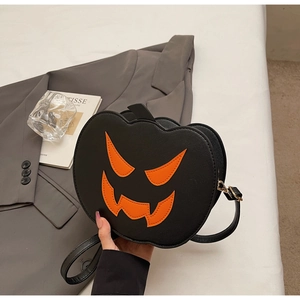 Detail of Halloween pumpkin crossbody bag with orange jack-o-lantern face on gray suit jacket