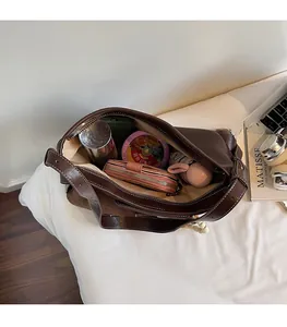 Spacious interior of brown suede tote bag showing large capacity for daily essentials