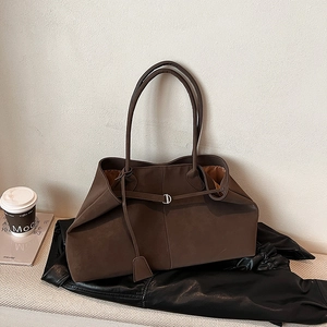 Detailed macro view of brown frosted tote bag featuring vintage silver D-ring hardware