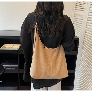 Rear view of camel suede large tote bag with adjustable shoulder strap and hobo silhouette