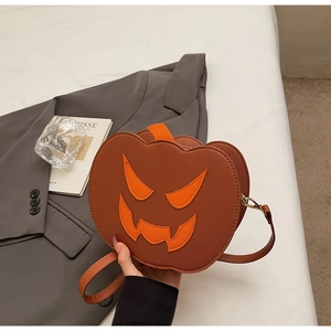 Detail of pumpkin crossbody bag with stitched face and saffiano leather texture