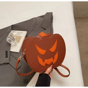 Detail of cross-grain PU leather pumpkin bag with orange face patch and gold buckles