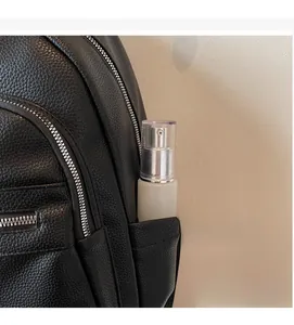 Detail of black pebbled leather backpack side pocket showing spacious storage capacity