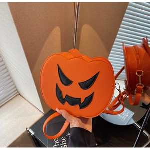 Close-up of orange pumpkin crossbody bag with zipper and golden metal hardware details