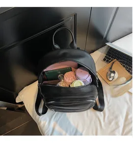 Detailed interior of black pebbled leather backpack showing large storage capacity