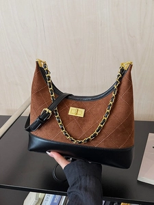 Brown suede hobo bag with quilted stitching and gold chain strap in hand display