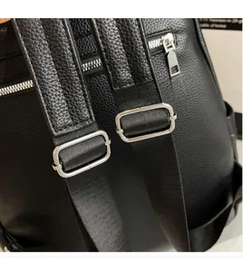 Detailed view of adjustable leather straps and hidden back zipper pocket on black backpack