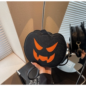 Close-up of Halloween pumpkin crossbody bag with orange devil face embroidery and pebble leather