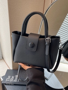 Elegant black pebble leather handbag with top handles and adjustable strap for women