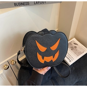 Detail of Halloween pumpkin crossbody bag in black lychee leather with orange devil face