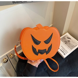 Detail of orange pumpkin bag with black face pattern and silver zipper for Halloween