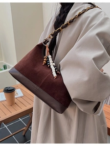 Brown vintage suede crossbody bag with metal chain strap and colorful bead charm decoration
