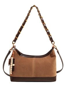 Brown suede hobo bag with chain strap and boho beaded charm on white background