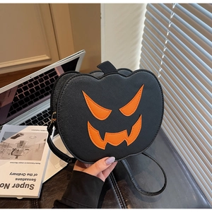 Detail of Halloween pumpkin crossbody bag with jack-o-lantern face and fine PU leather texture