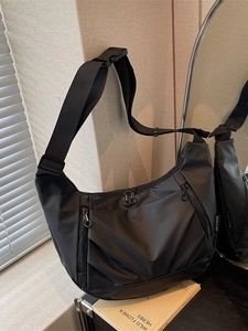 Black Oxford nylon crescent crossbody bag with multi-pocket design and adjustable strap