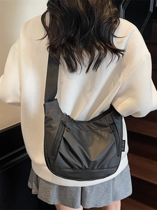 Lightweight black oxford dumpling bag for women with multiple zipper pockets and sleek design