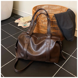 Detail shot of the large dark brown PU leather tote with reinforced handles and metal zipper