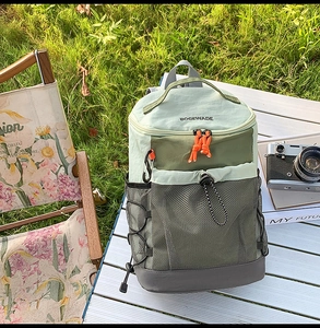 Détail d'un sac à dos d'extérieur en nylon vert avec plusieurs poches et filet de rangement
