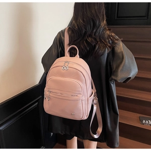 Pink lychee texture leather backpack featuring multi-pocket design and silver hardware details