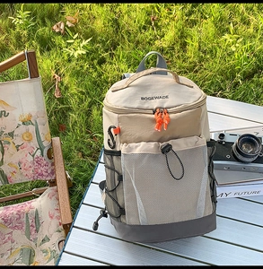 Sac à dos de camping avec poche en filet kaki et mousqueton sur table de pique-nique