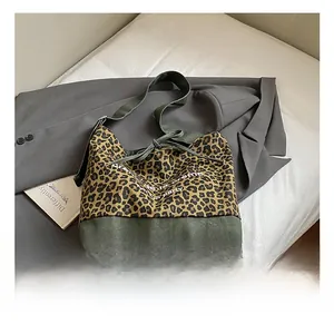 Close-up of leopard print canvas tote bag with green fabric detail and white lettering