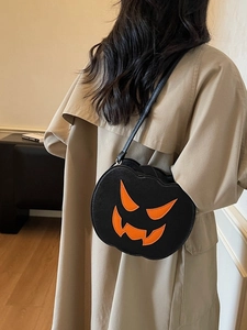 Fashionable Halloween pumpkin-shaped crossbody bag in black with orange Jack-o'-lantern face