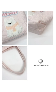 Detail view of pink heart-quilted tote bag featuring a cute puppy embroidery and stitching