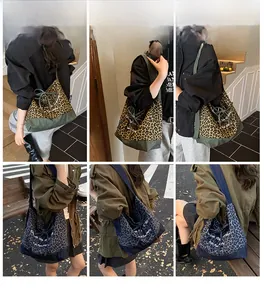 Detail view of leopard print denim tote bags in camel and grey-blue with drawstring