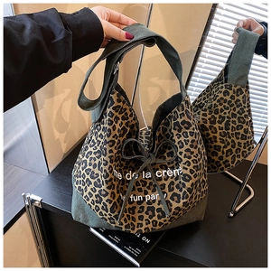 Leopard print denim tote bag with drawstring detail and mirror reflection view