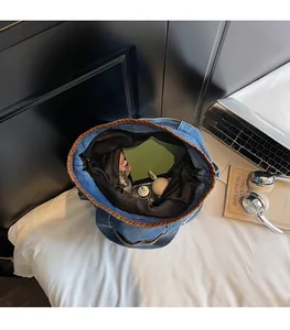 Interior view of denim bucket bag showing large capacity for books and cosmetics