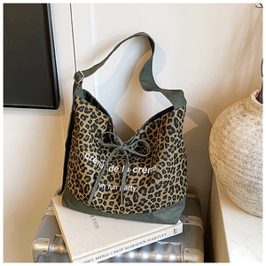 Detailed leopard print canvas tote bag with green bottom and adjustable shoulder strap