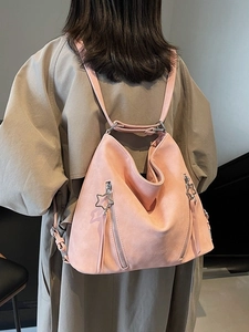 Pink suede convertible tote backpack with star zippers shown from a rear back view