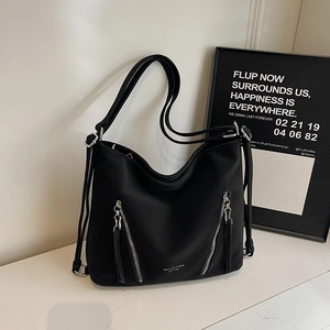 Detail of black Hobo tote bag with dual silver zippers and durable nylon texture