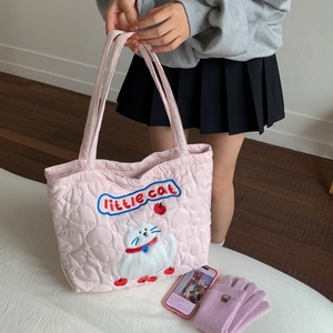 Close-up of pink quilted tote bag with heart patterns and cute embroidered cat detail