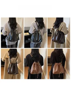 Detail showing the pleated bucket bag styles in black and brown with pearl charms