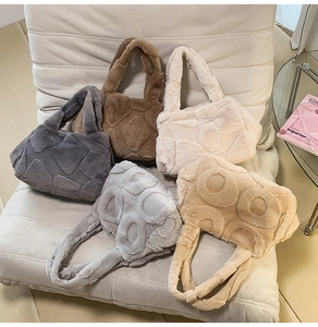 Macro detail of plush faux fur tote bags with geometric patterns in five neutral colors