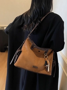 Large brown suede tote bag for women with colorful wood bead pendant and sleek metal logo