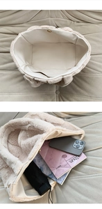 Macro view of plush off-white tote bag interior showing large capacity and snap button